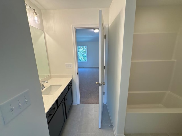 bathroom with plus walk in shower, vanity, and tile patterned floors