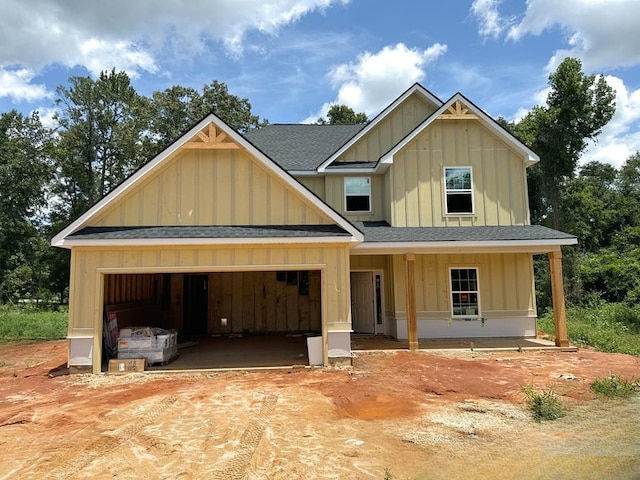 view of front facade featuring covered porch and a garage