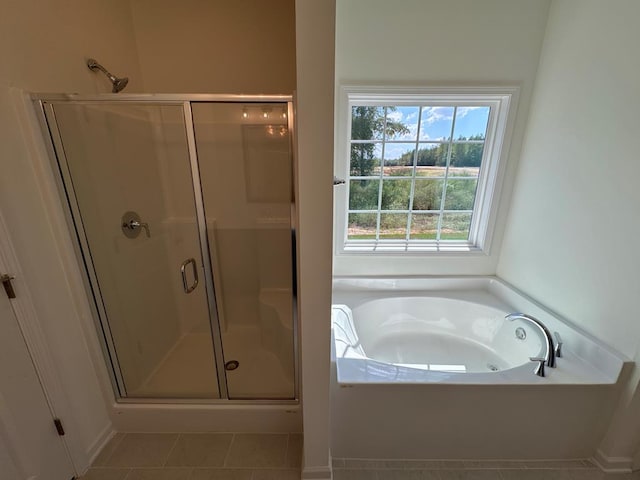 bathroom featuring tile patterned flooring and shower with separate bathtub