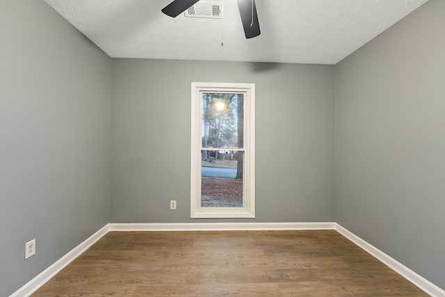 unfurnished room with ceiling fan, a textured ceiling, and hardwood / wood-style flooring