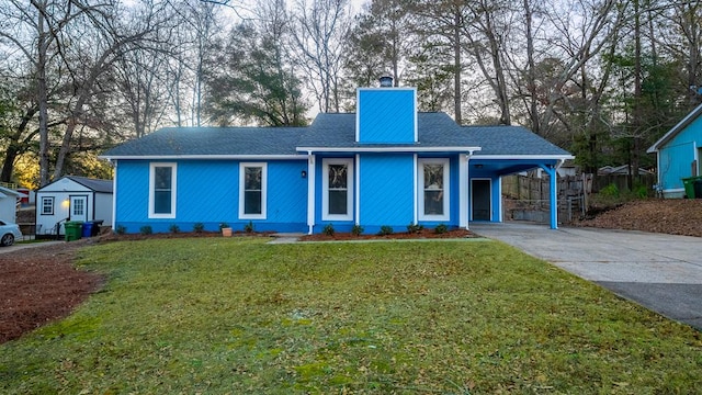 view of front of property with a front lawn and a carport