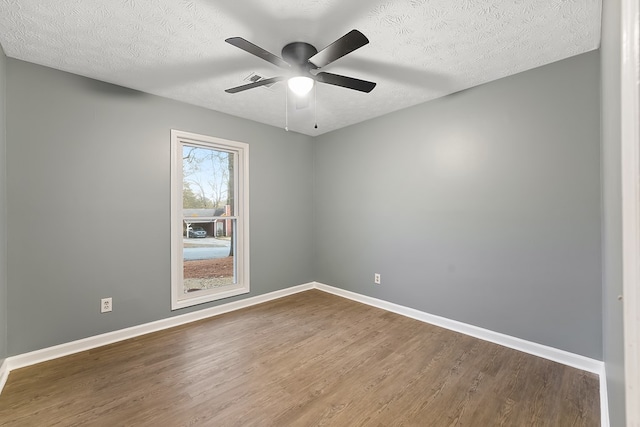 unfurnished room with ceiling fan, hardwood / wood-style floors, and a textured ceiling