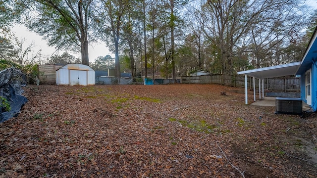 view of yard featuring central AC unit and a storage unit