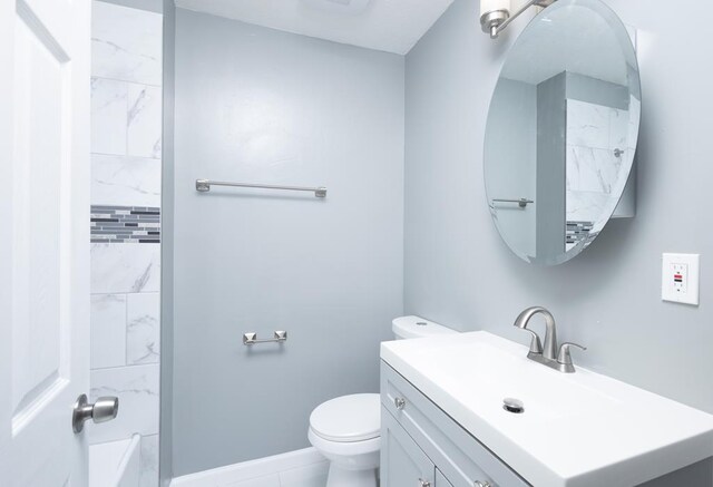 bathroom featuring vanity, tile patterned floors, toilet, and walk in shower