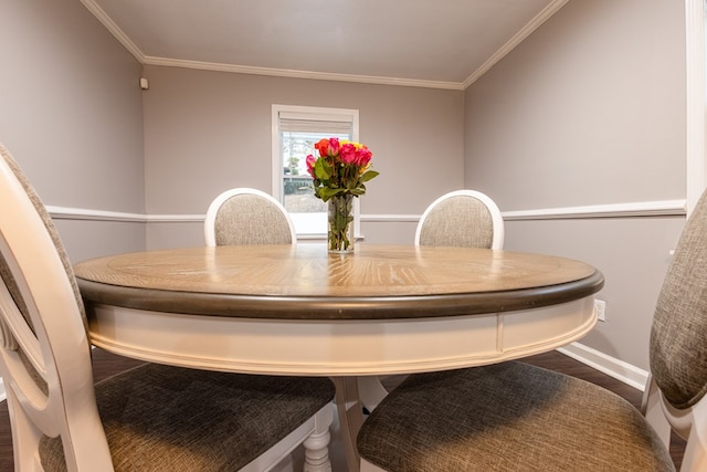 dining space with ornamental molding and hardwood / wood-style floors