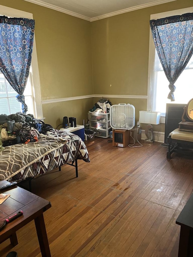 interior space featuring ornamental molding and hardwood / wood-style flooring