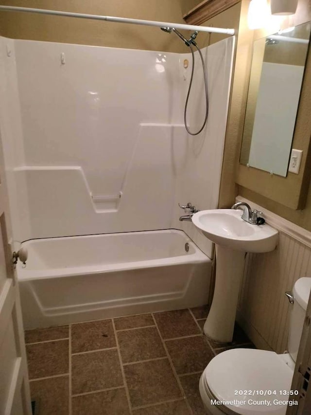 bathroom featuring shower / bathing tub combination and toilet