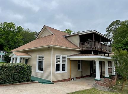 back of property featuring a balcony