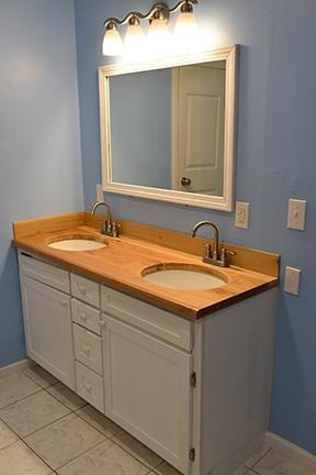 bathroom featuring tile patterned flooring and vanity