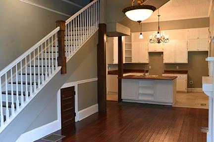 kitchen with sink, decorative light fixtures, a chandelier, dark hardwood / wood-style floors, and white cabinetry