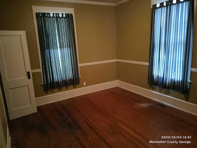 unfurnished room featuring hardwood / wood-style floors and ornamental molding