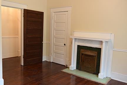 unfurnished living room with dark hardwood / wood-style floors