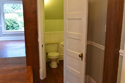 bathroom with wood-type flooring and toilet