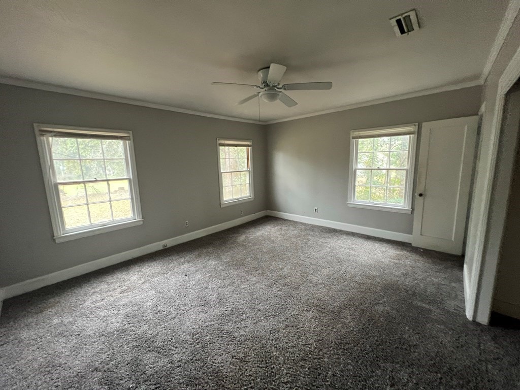 815 W Lafayette St, Valdosta, GA 31643 - carpeted spare room with ornamental molding, baseboards, and a ceiling fan