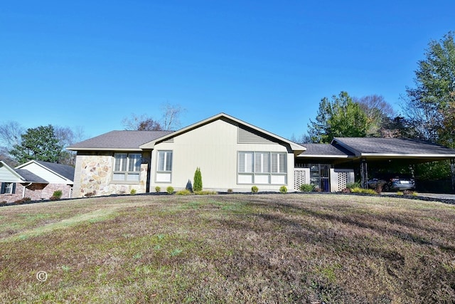 ranch-style house with a carport and a front yard