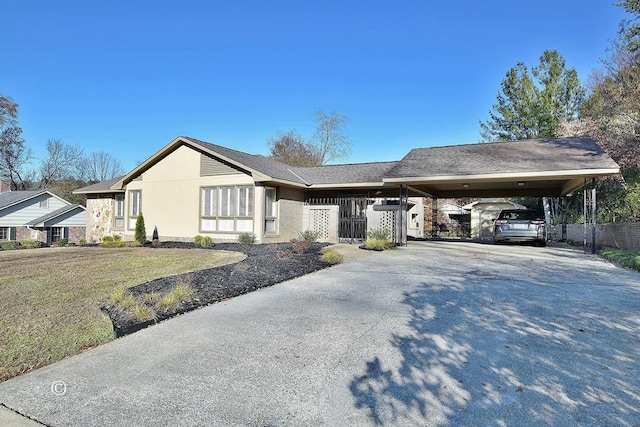 ranch-style home featuring a front yard and a carport