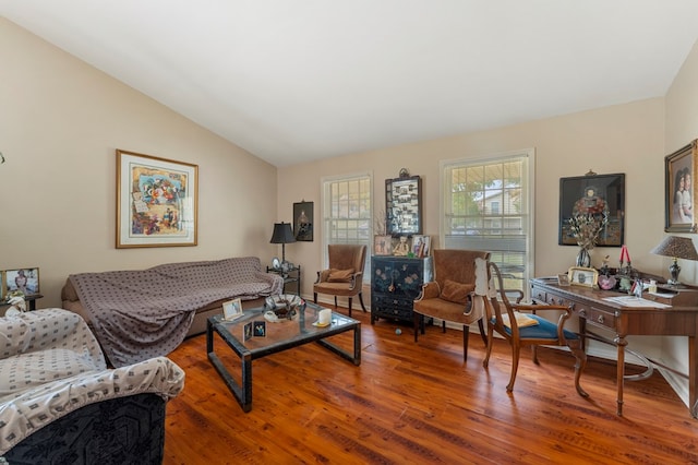 living room with hardwood / wood-style flooring and vaulted ceiling