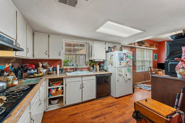 kitchen with black appliances, white cabinetry, light wood-type flooring, and sink