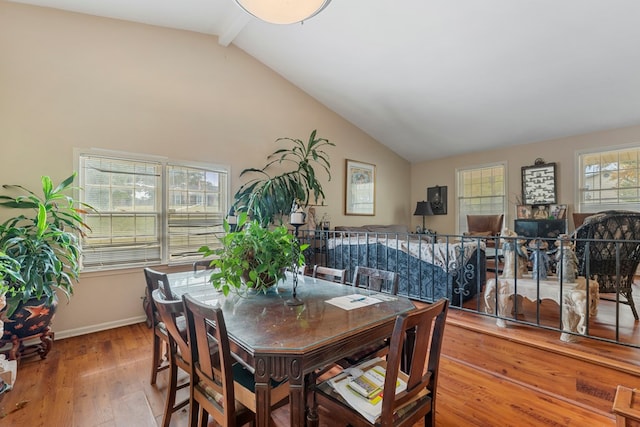 dining room featuring hardwood / wood-style floors and vaulted ceiling