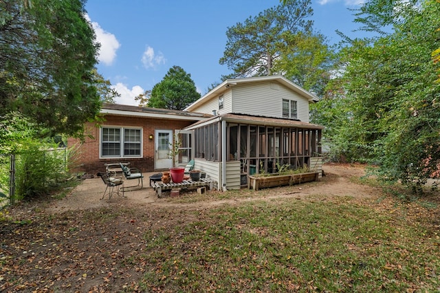 back of house with a sunroom and a patio