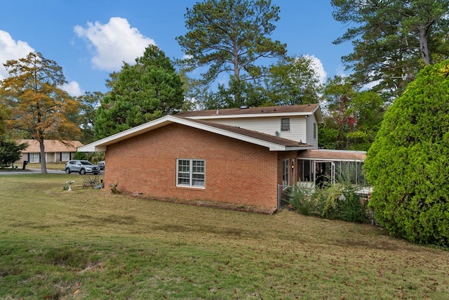 view of side of home with a lawn