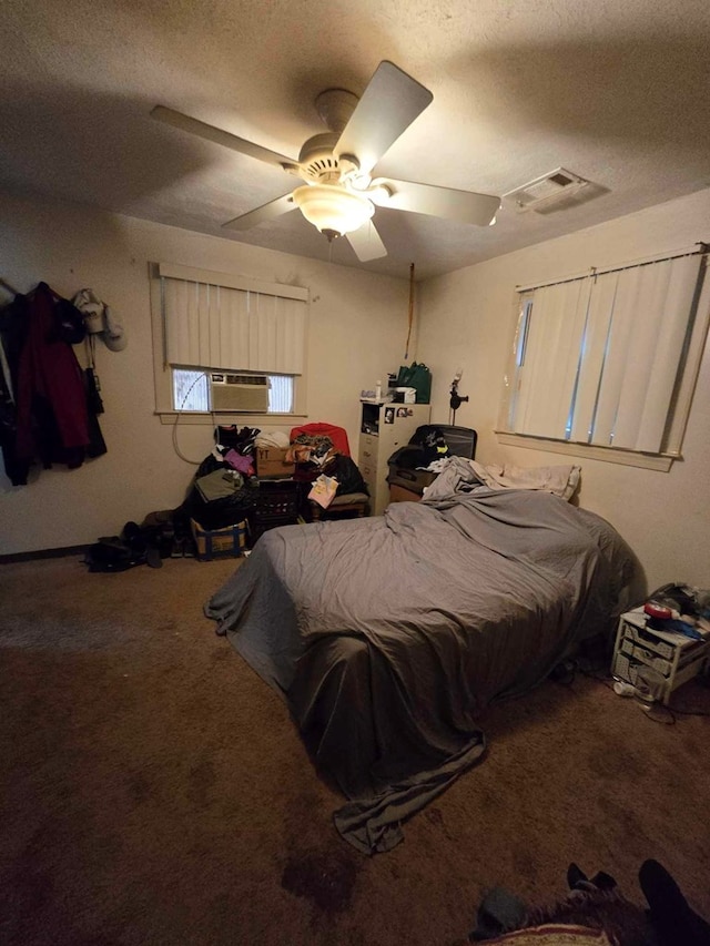 bedroom with carpet flooring, ceiling fan, and a textured ceiling