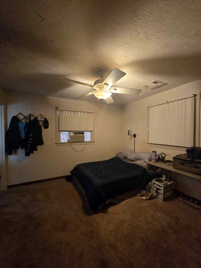 bedroom with cooling unit, carpet floors, and a textured ceiling