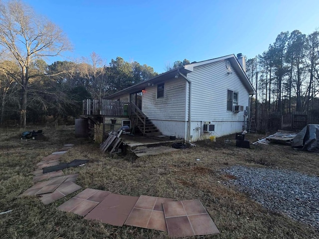 view of property exterior featuring a wooden deck