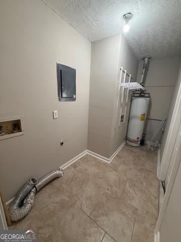 clothes washing area with hookup for a washing machine, water heater, a textured ceiling, and hookup for an electric dryer