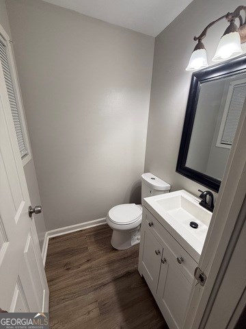 bathroom featuring hardwood / wood-style flooring, vanity, and toilet