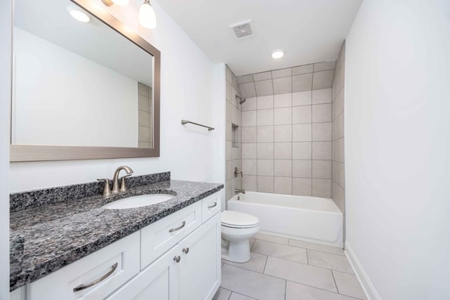 full bathroom featuring tile patterned flooring, vanity, toilet, and tiled shower / bath combo