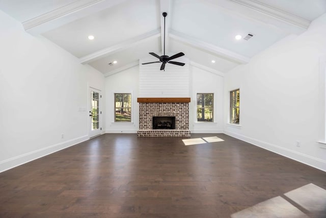 unfurnished living room with beam ceiling, ceiling fan, a fireplace, and dark hardwood / wood-style floors