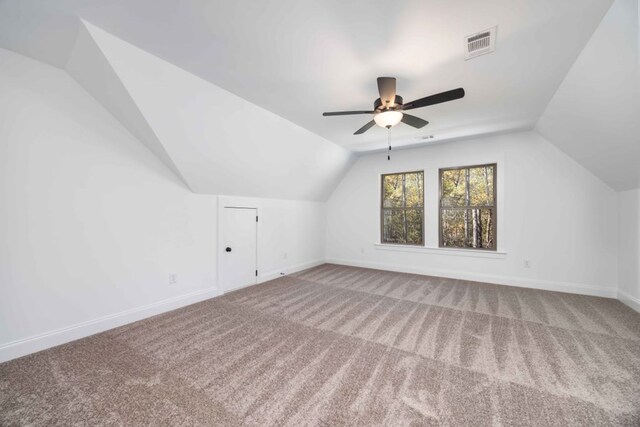 additional living space with carpet flooring, ceiling fan, and lofted ceiling