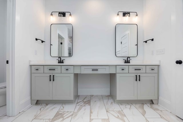 bathroom featuring vanity and toilet