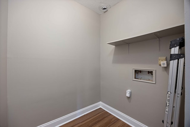 laundry area featuring hookup for a washing machine, dark wood-style floors, baseboards, laundry area, and a textured ceiling