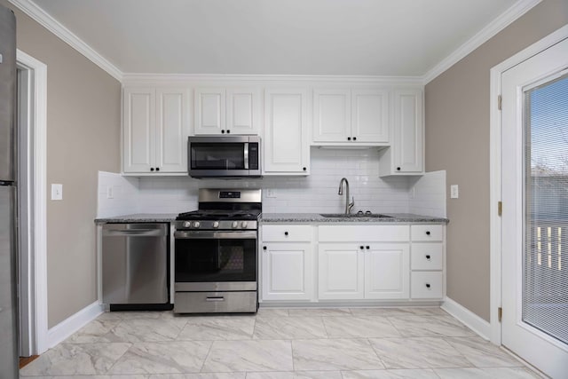 kitchen featuring light stone counters, appliances with stainless steel finishes, marble finish floor, white cabinetry, and a sink