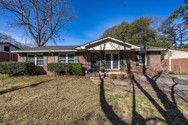 ranch-style home with brick siding and a front lawn