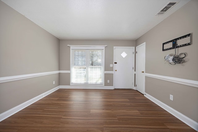 entrance foyer featuring visible vents, baseboards, and wood finished floors