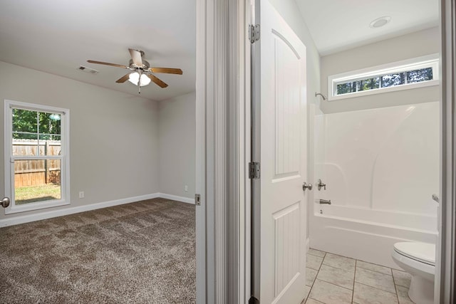 bathroom featuring shower / bathing tub combination, toilet, ceiling fan, and tile patterned floors