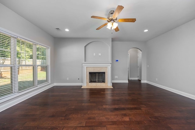 unfurnished living room featuring ceiling fan and dark wood-type flooring