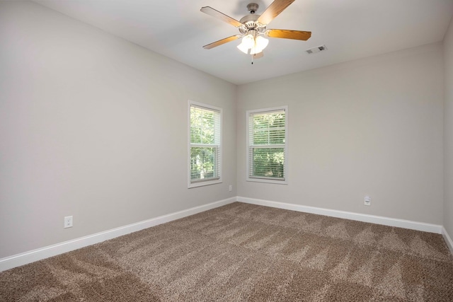 empty room featuring ceiling fan and carpet floors