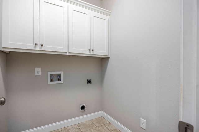 clothes washing area with cabinets, washer hookup, light tile patterned floors, and electric dryer hookup