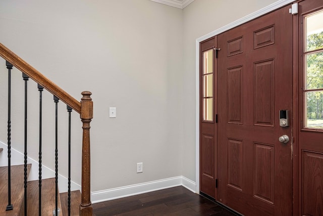 entrance foyer featuring dark hardwood / wood-style flooring and crown molding