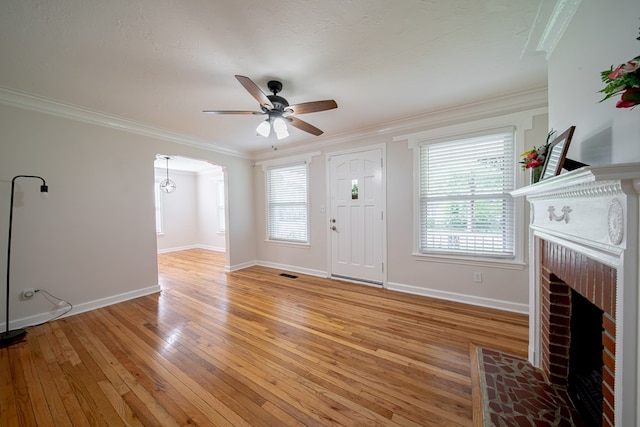 1729 41st St, Columbus, GA 31904 - foyer entrance featuring a brick fireplace, light wood-style floors, healthy amount of natural light, baseboards, and ornamental molding