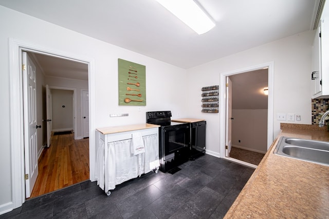 1729 41st St, Columbus, GA 31904 - kitchen featuring black / electric stove, a sink, white cabinetry, light countertops, and baseboards