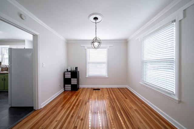 1729 41st St, Columbus, GA 31904 - unfurnished dining area featuring light wood-style floors, baseboards, and ornamental molding