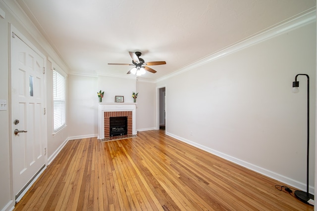 1729 41st St, Columbus, GA 31904 - unfurnished living room with a brick fireplace, light wood-style floors, a ceiling fan, baseboards, and crown molding