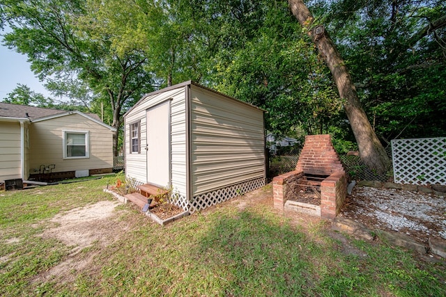 1729 41st St, Columbus, GA 31904 - view of shed featuring an outdoor brick fireplace