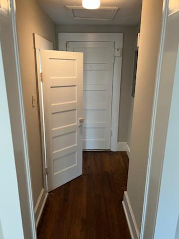 3515 Edgewood Rd, Columbus, GA 31907 - hallway with attic access, dark wood-type flooring, and baseboards