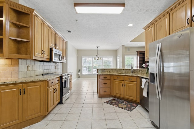 kitchen with open shelves, a sink, stainless steel appliances, a peninsula, and visible vents